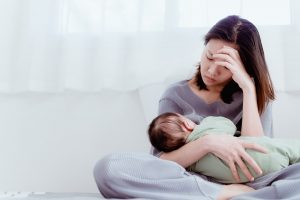 Woman suffering from postpartum depression symptoms